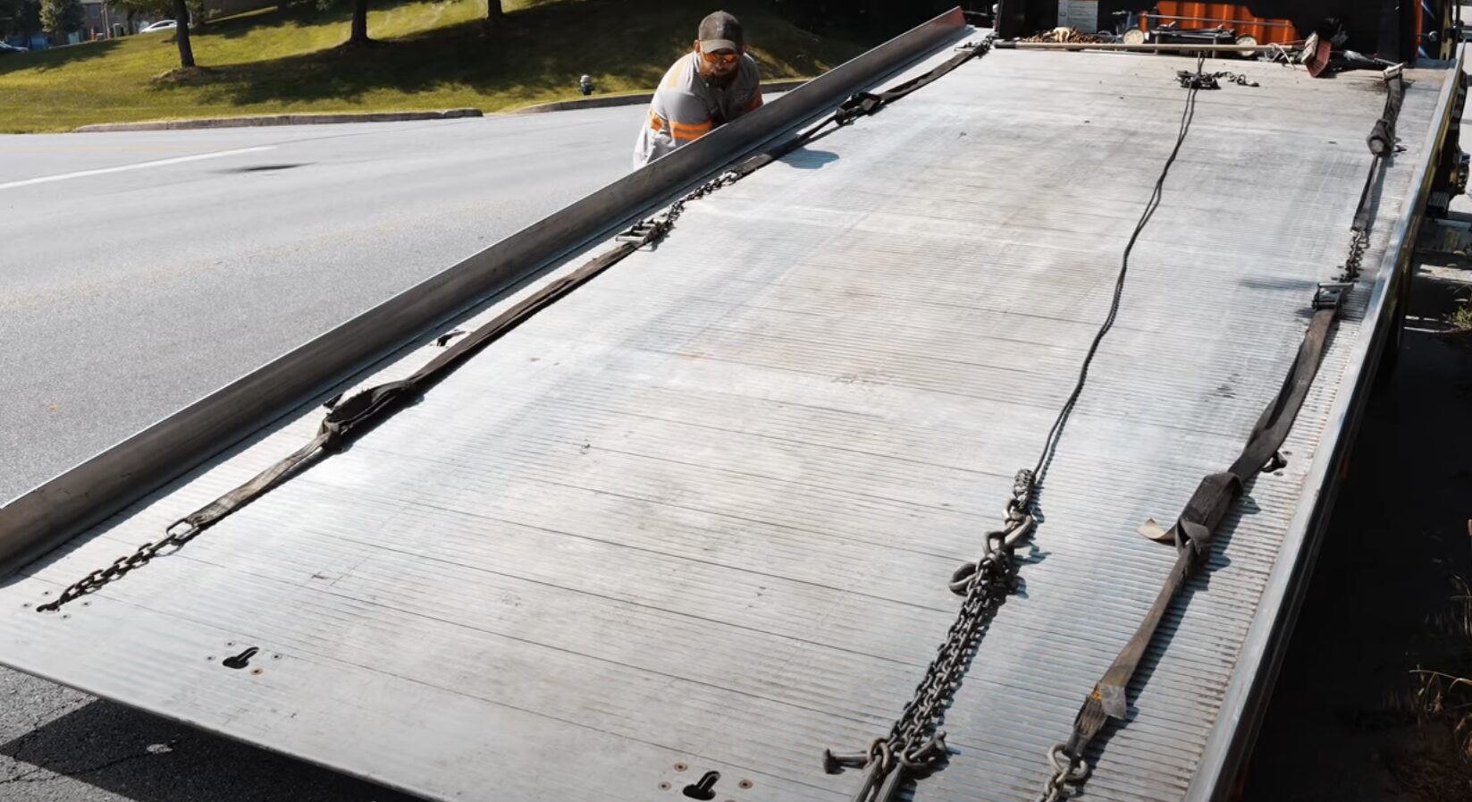 Flatbed tow truck with winch system and chains for emergency vehicle recovery