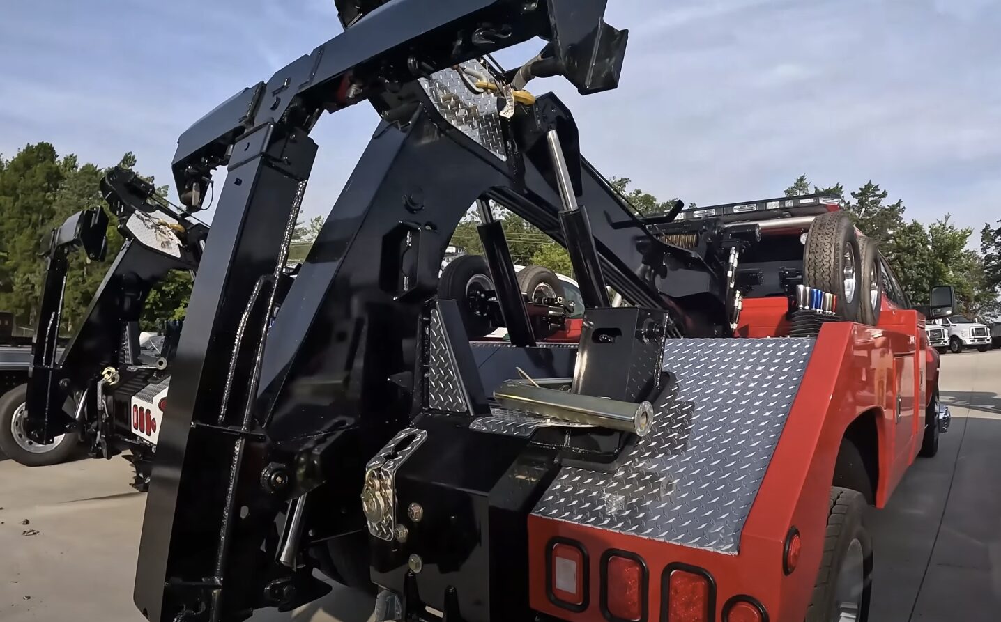 Heavy-duty tow truck with extended boom and recovery equipment ready for vehicle extraction and winching operations