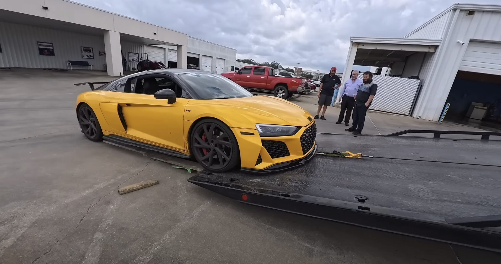 Flatbed Towing for Luxury and Sports Cars Yellow Audi R8 sports car being loaded onto professional flatbed tow truck